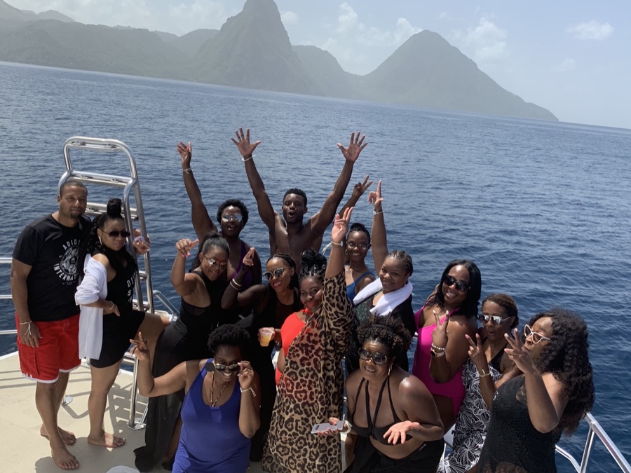 UEG group on a catamaran in St. Lucia with the Piton mountains
